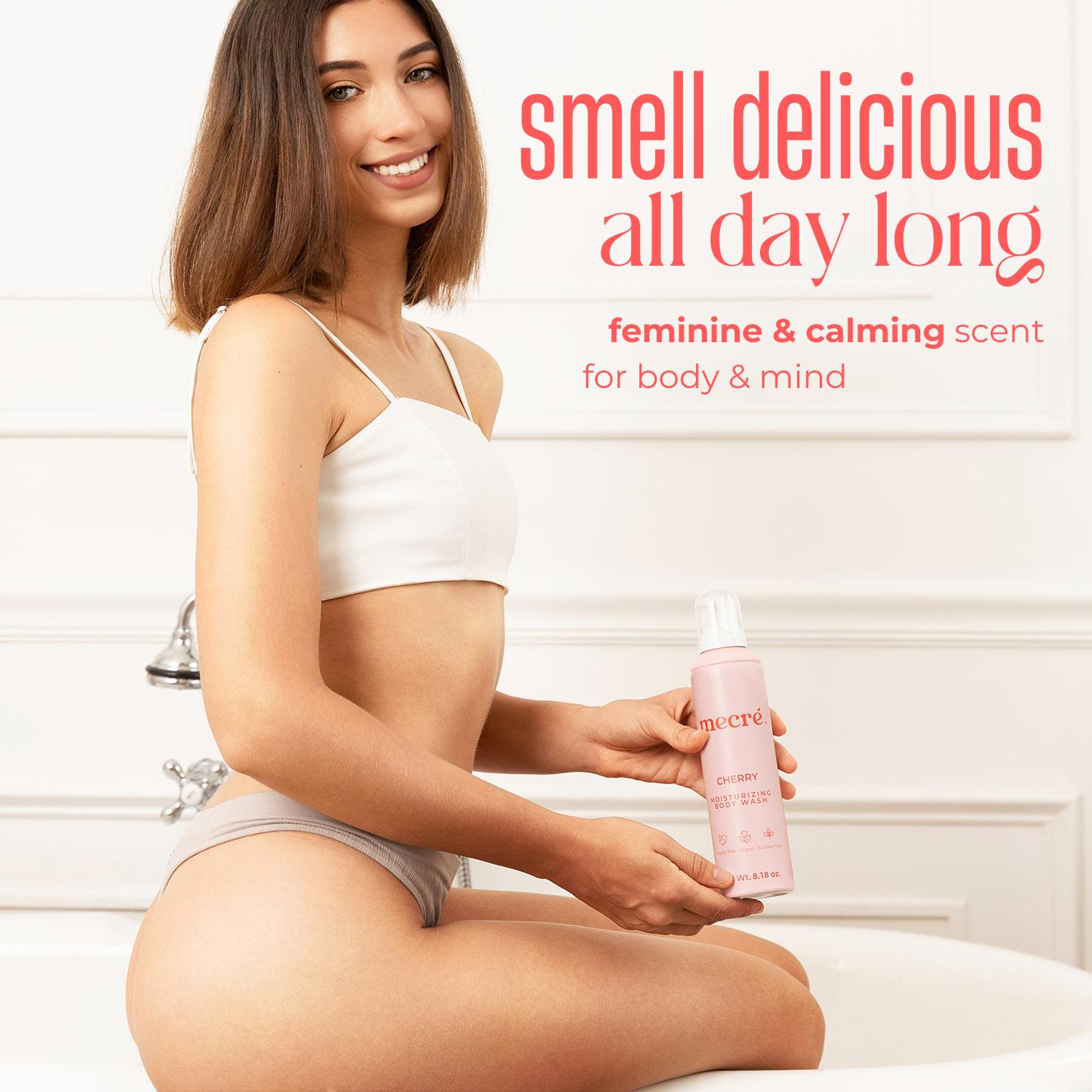 Girl sitting on the edge of a bathtub, smiling and holding a cherry mecré bottle. The image includes text that reads: “Smell delicious all day long, feminine & calming scent for body & mind.”