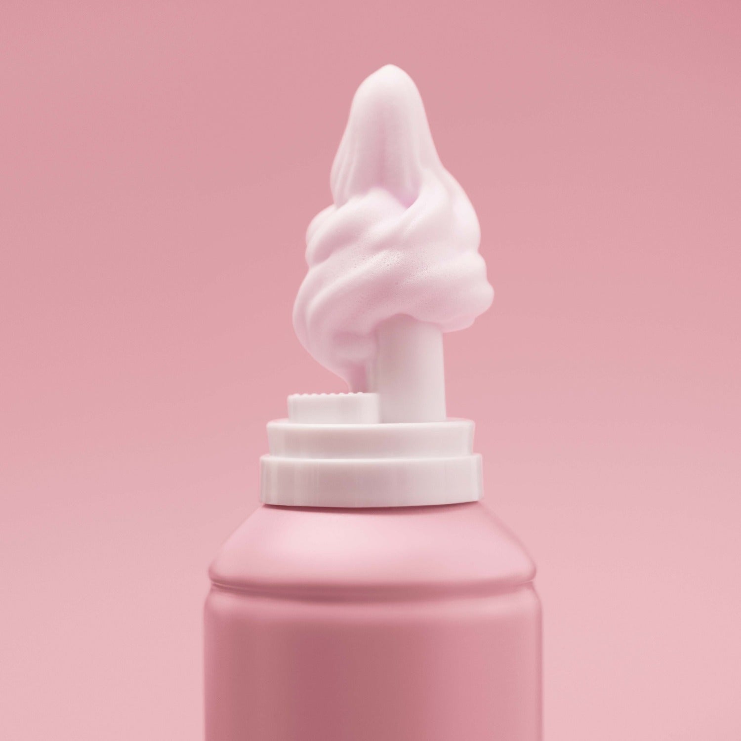 Close-up of foam coming off the nozzle of the cherry-scented Mecré moisturizing body wash bottle.