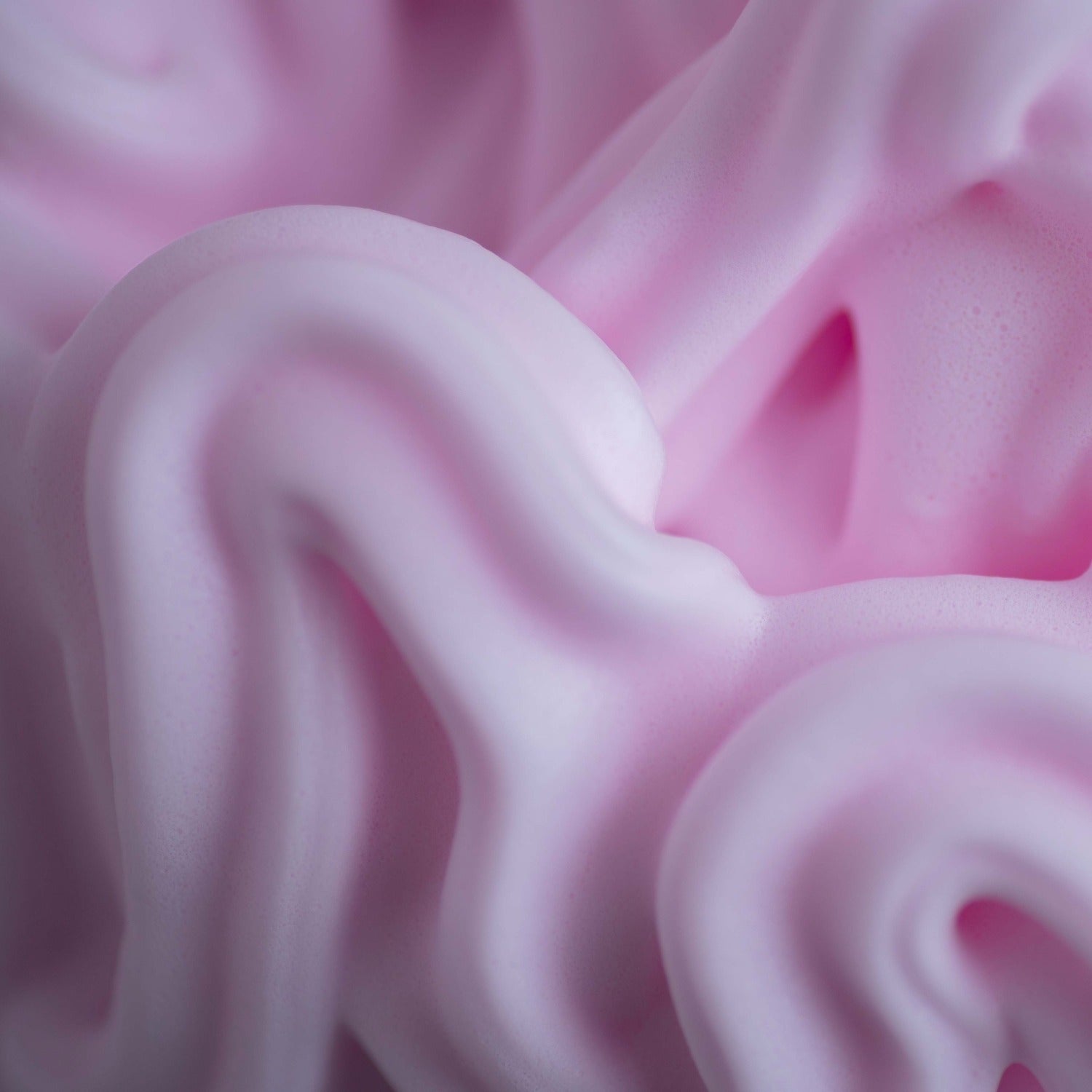 Close-up of Mecré moisturizing body wash with cherry scent, showcasing dense, pinkish foam.