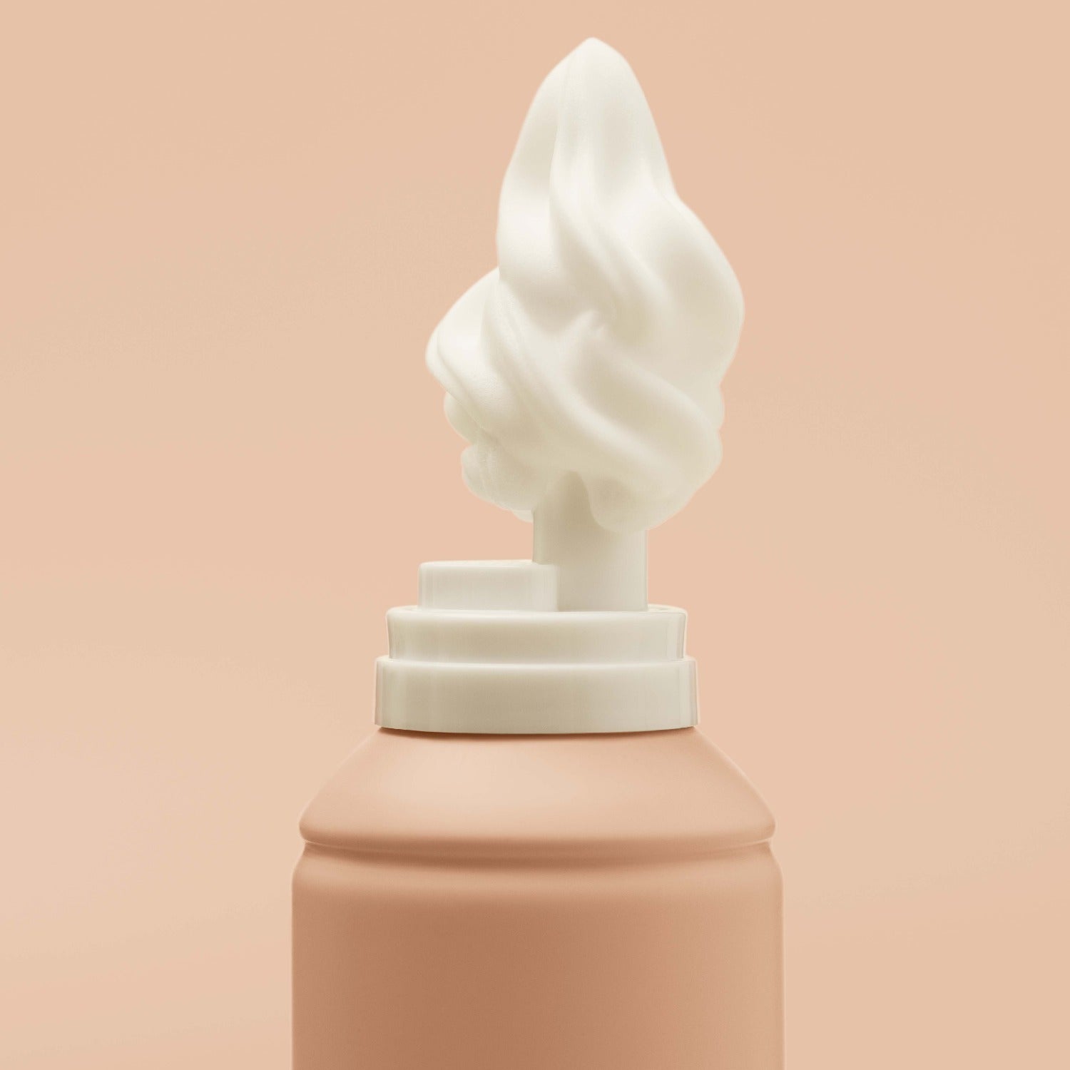 Close-up of foam coming off the nozzle of the coconut-scented Mecré moisturizing body wash bottle.